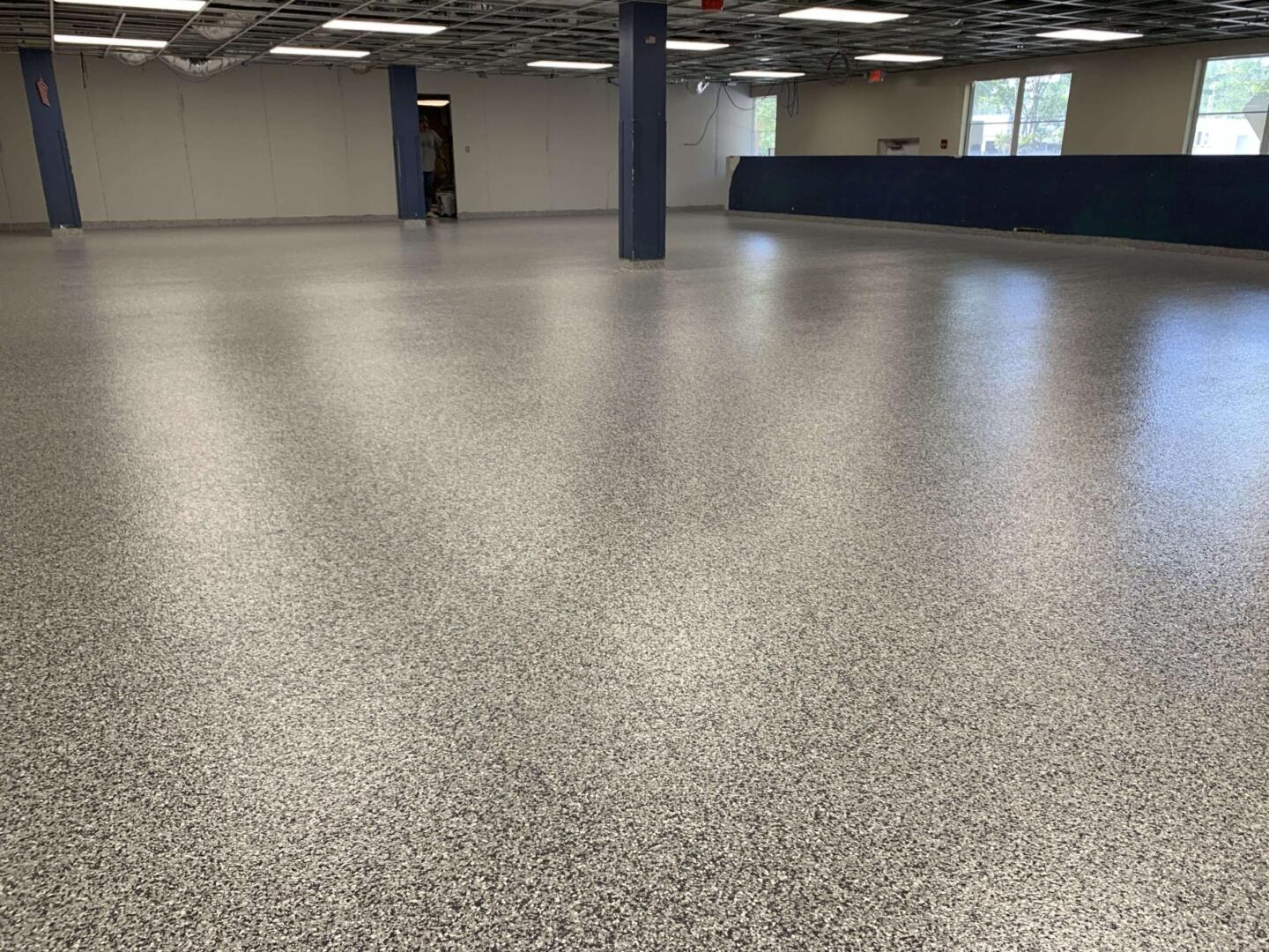 Epoxy Flooring project by Concrete Ideas Florida: Decorative flake epoxy system with broadcast chip texture and clear topcoat.
