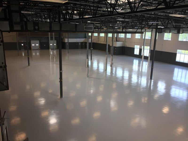 Epoxy Flooring project by Concrete Ideas Florida: Industrial epoxy floor with safety striping and durable protective coating.