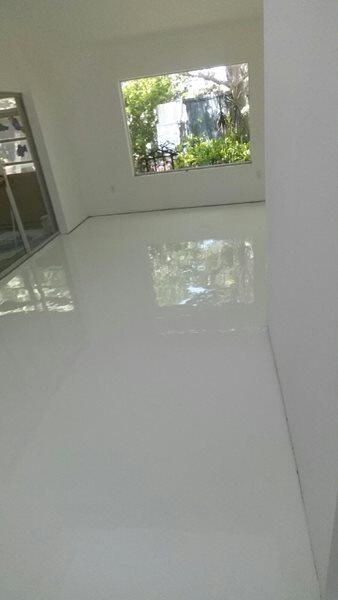 Epoxy Flooring project by Concrete Ideas Florida: High-gloss epoxy floor with reflective finish and seamless surface.