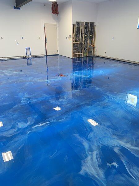 Metallic Epoxy project by Concrete Ideas Florida: Metallic epoxy floor with swirling color movement and high-gloss depth.