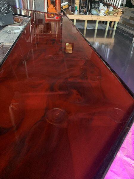 Metallic Epoxy project by Concrete Ideas Florida: High-gloss metallic epoxy finish with reflective surface and color variation.